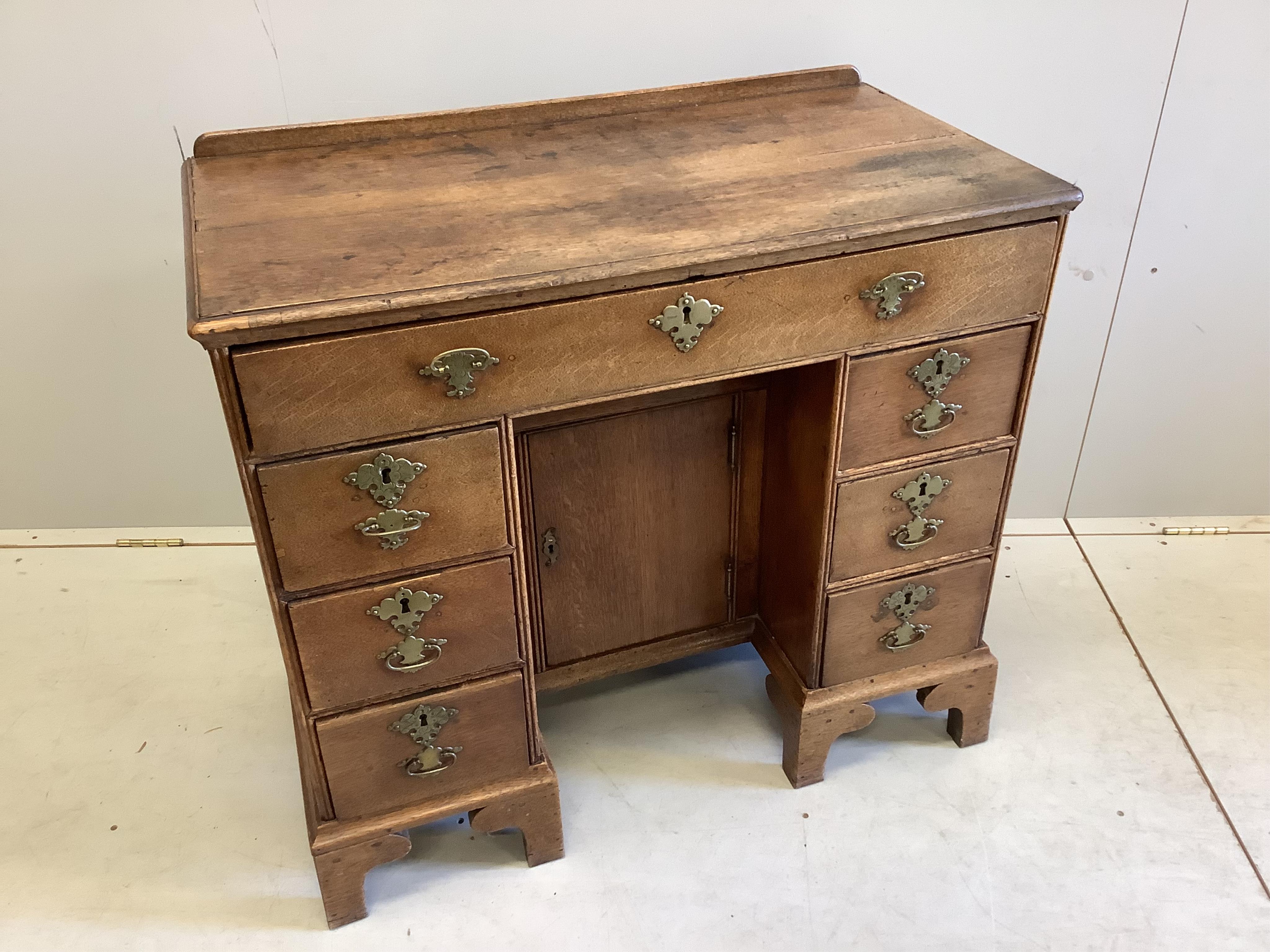 A George lll Provincial oak kneehole desk, width 86cm, depth 46cm, height 78cm. Condition - fair
